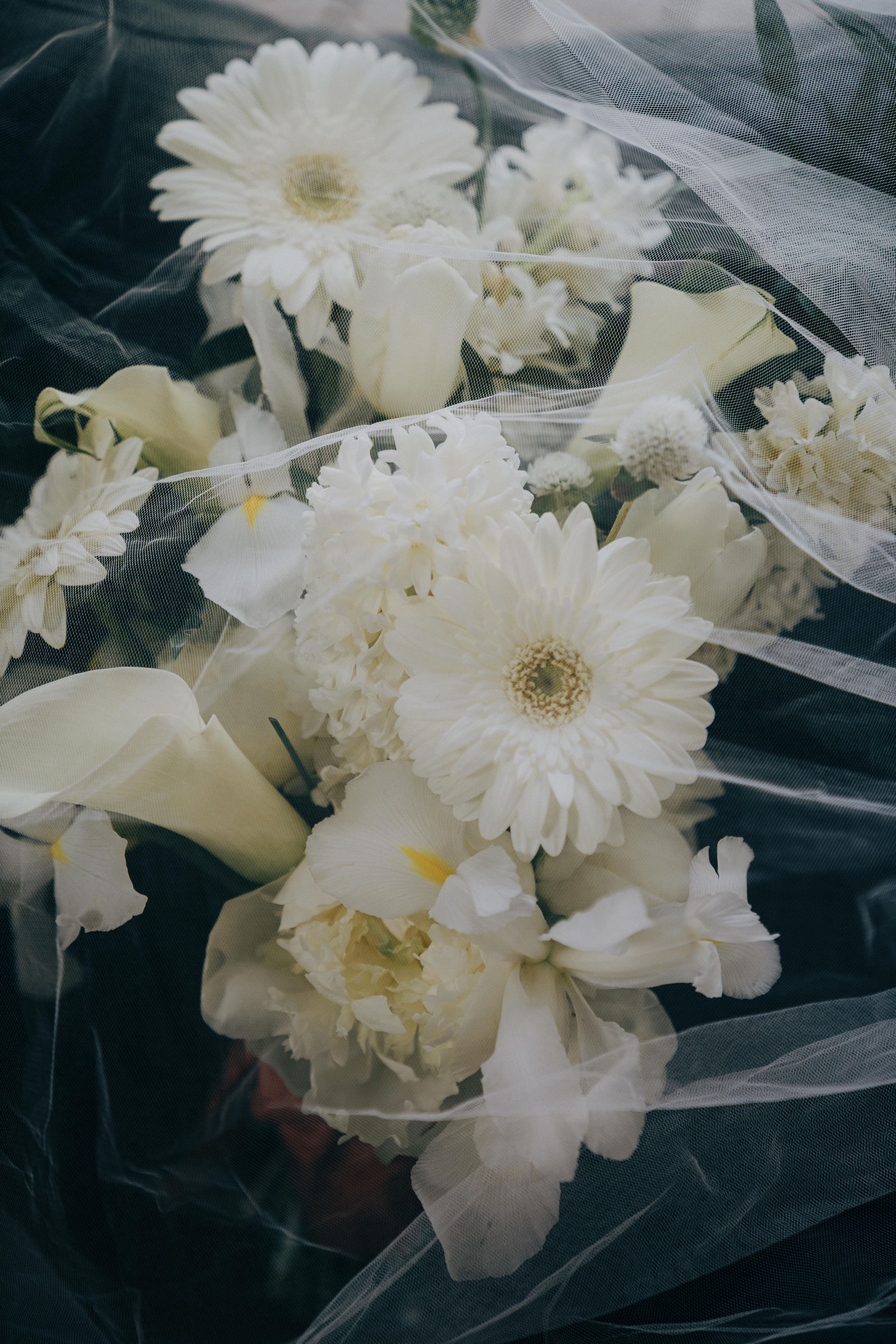 A white bridal bouquet of gerberas, callas and roses, close up