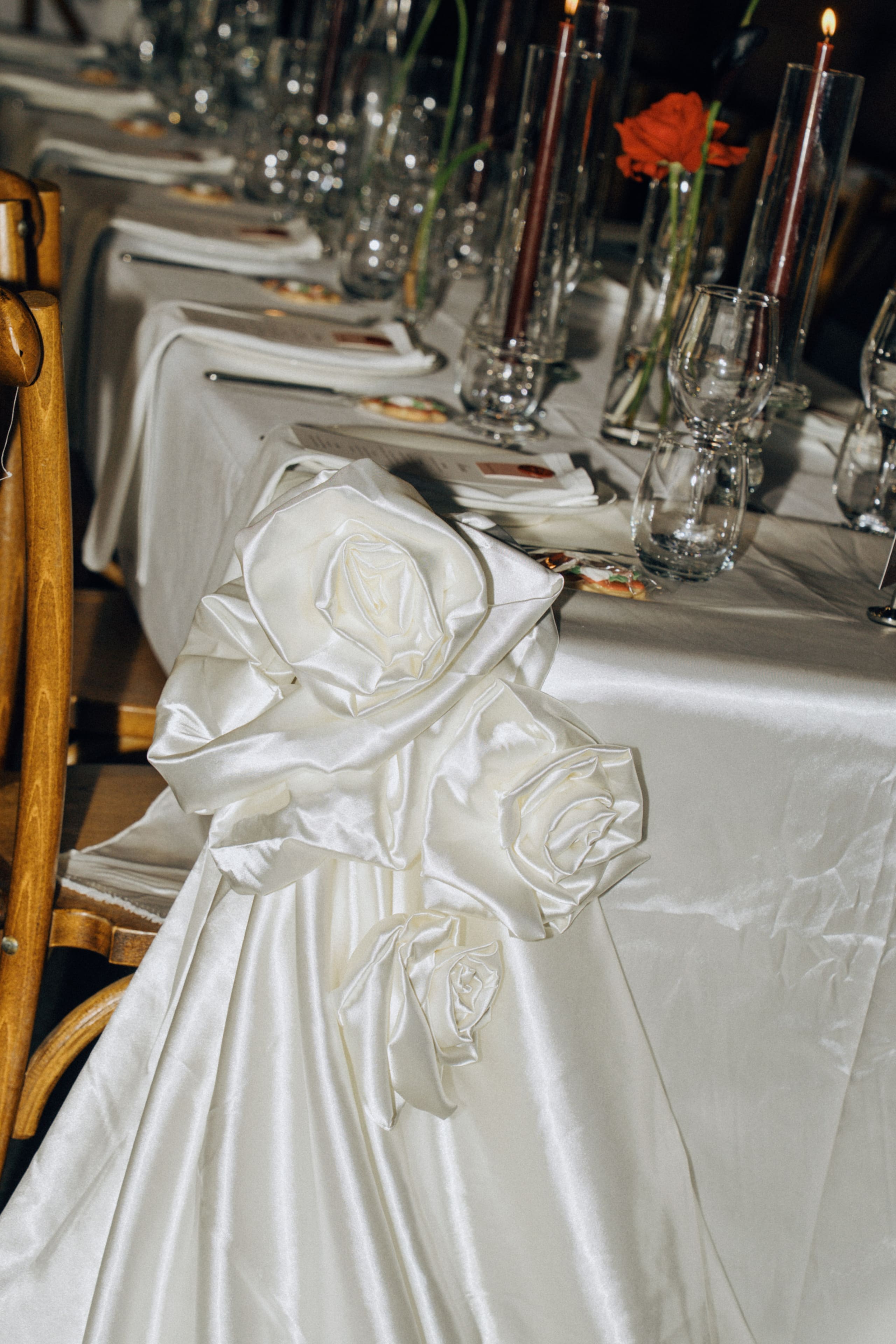 Sculpted ivory satin roses along the reception table